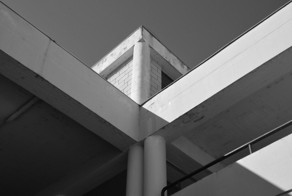 Minimalist black and white photo of a geometric architectural structure with concrete elements.
