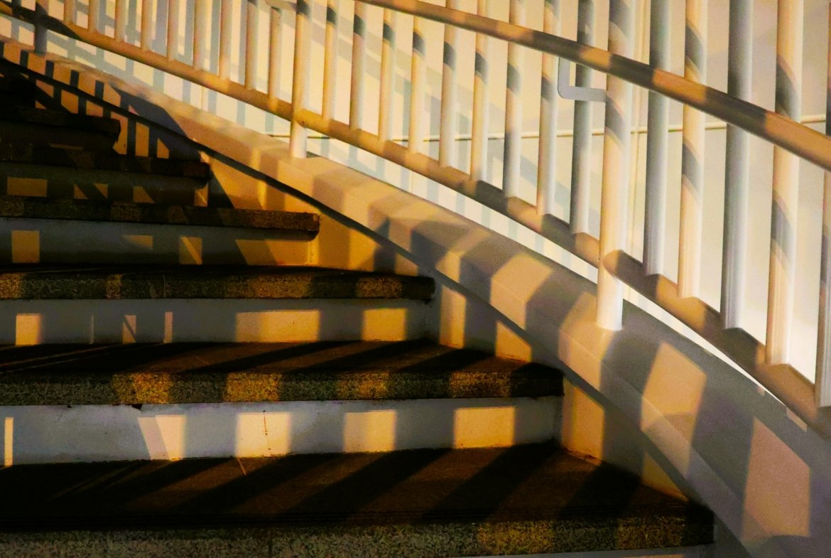 Artistic view of a curved staircase with dramatic shadows in Taiwan, captured at night.